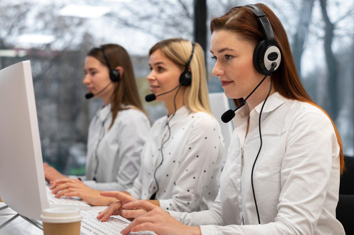 colleagues-working-together-call-center-with-headphones.jpg__PID:1ba9f59b-268f-44a2-8160-5b8d7cd1c128